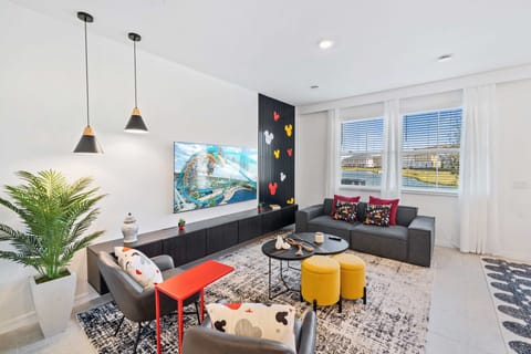 Enchanting Living Area of the Townhouse in Davenport Florida - Smart TV and Netflix - Elegant Micky Themed decor - Stylish furniture arrangement providing comfort and a cohesive look