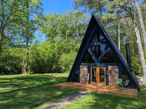 Arrive at the magical glow of your private A-frame tucked away in the Alabama woods. Captivating A-Frame retreat boasting unparalleled panoramic views.