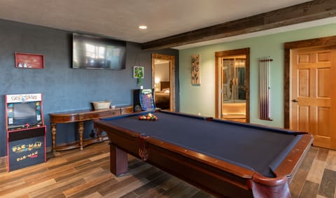 Game room downstairs offer a pool table and two arcade game consoles.