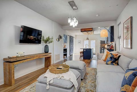 Welcome to a bright, open-plan living room with seamless flow into the dining and kitchen areas. Enjoy a large Smart TV and relax on a comfortable modular couch—perfect for unwinding after a day of exploring.