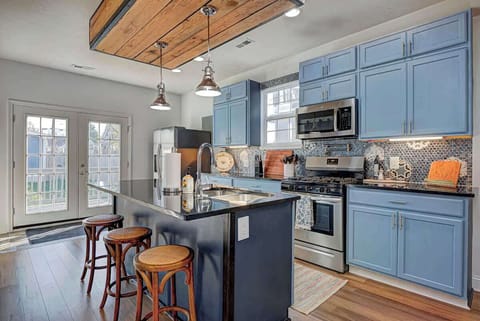 The fully equipped kitchen has everything you need, including cooking utensils, dishes, and cups. A coffee bar, complete with sugar and creamer, adds convenience, and the island seats 3 comfortably for dining or meal prep.