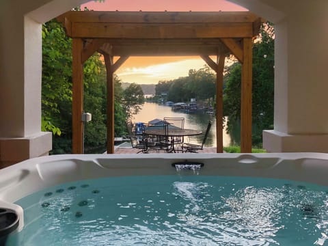 Soak in the hot tub overlooking the serene cove.