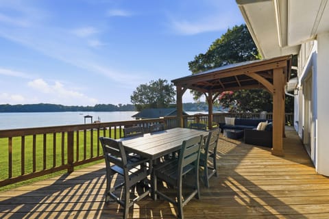 Dine and lounge on the spacious waterfront deck, with a shaded seating area and wide-open lake views.