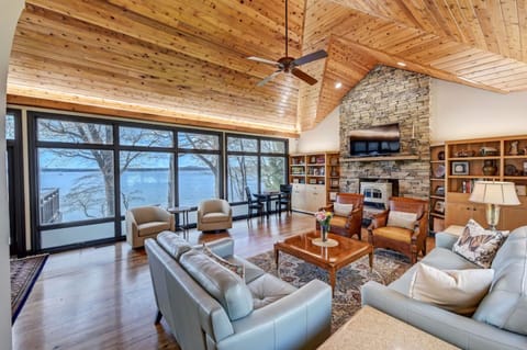 Main Level Living room with updated furnishings, new couches, chairs, and decor along with amazing lake views. 