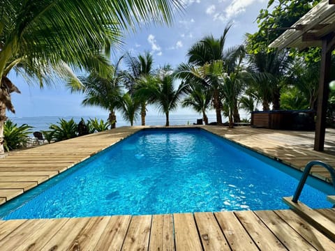 Pool on the deck at Haapiti, palms and the lagoon beyond