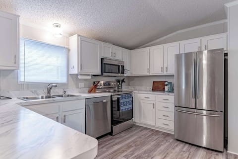 Kitchen: Prepare your meals with ease in our kitchen, featuring modern appliances and a spacious marble countertop.