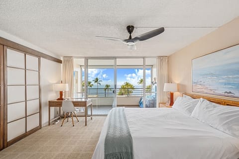 Master bedroom with sweeping ocean views and private access to double-size lanai