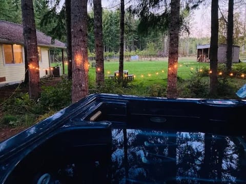 Hot soak under the trees with an orchard view