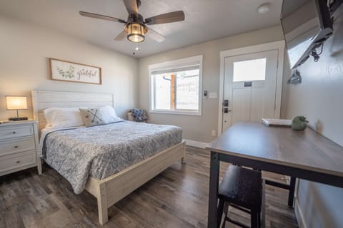 Comfortable queen bed with fresh farmhouse decor.