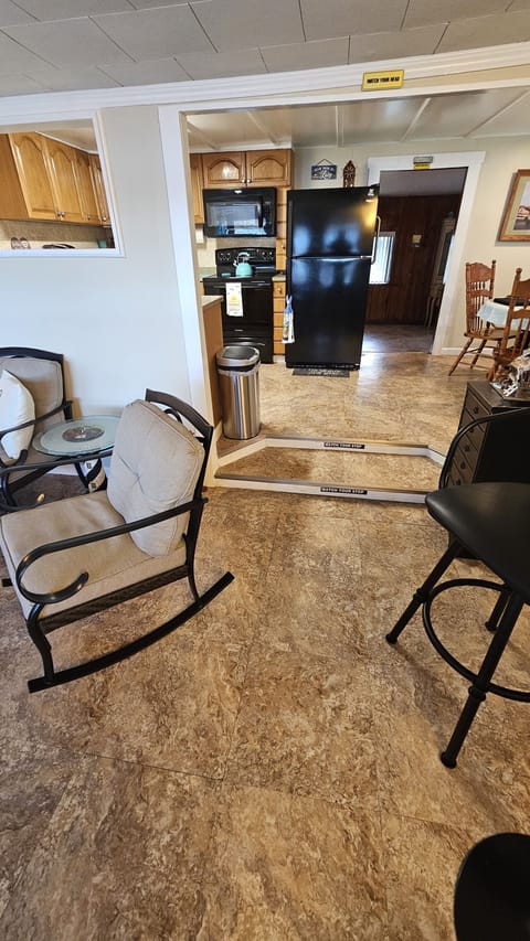 Florida room facing kitchen to left, livingroom straight ahead