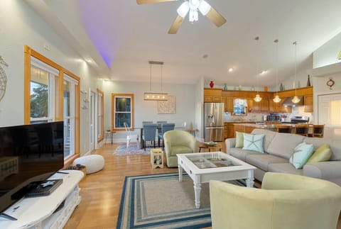 Living room upstairs with wide open layout and high ceilings