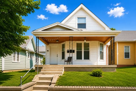 Charming covered front porch with string lights and free parking both front and back, steps from Mass Ave