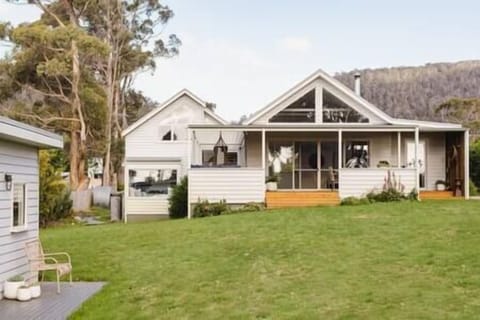 View of the house from the beach end, lots of soft manicured grass to play on.