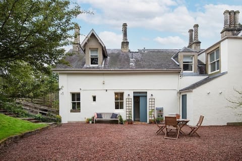 The Trouthouse - front aspect and entrance to the property with gravelled outdoor area, complete with table, chairs and bench seating