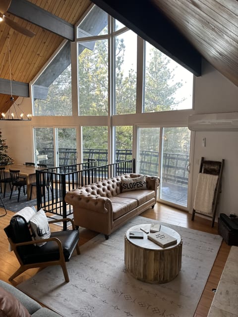 Cozy living room area with floor-to-window ceilings