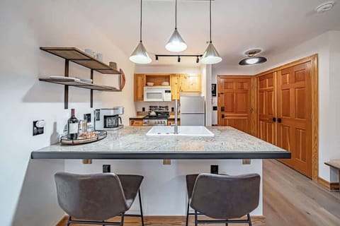 Large counter space and comfy bar stool seats make meals and socializing easy.