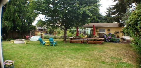 Looking across yard from unit entrance area. Garden sheds, chicken coop in back.