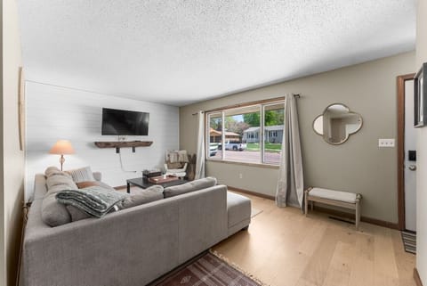 Relax in the cozy living room with a large window view.