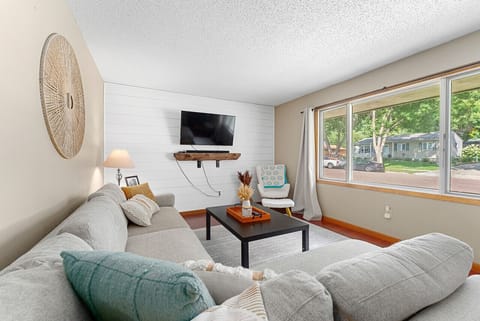 Relax in the cozy living room with a large window view.