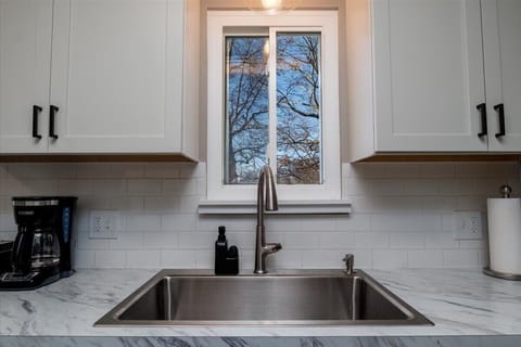 A large farmhouse sink completes the look in this updated kitchen.