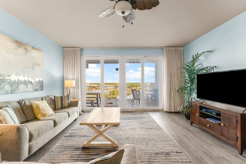 Lakefront Living Area with Flat Screen TV and Private Balcony Access