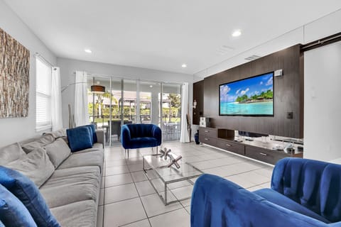 Spacious living room with large sectional sofa and modern entertainment center, ideal for family movie nights.