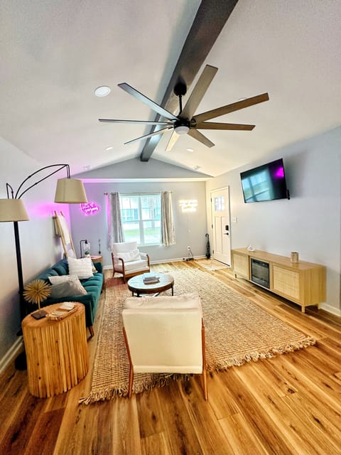 Open concept living room with lounging furniture, sofa converts into twin bed for extra sleep space