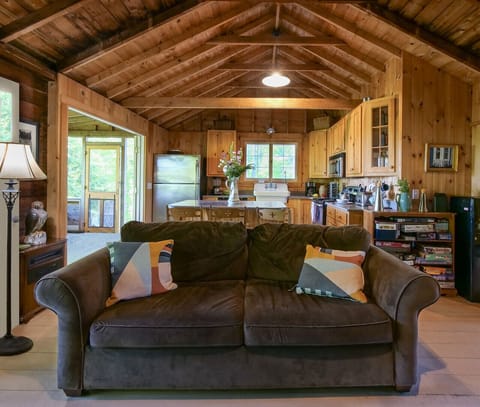 Living room open to kitchen and screen porch overlooking amazing lake views