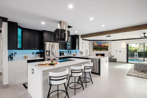 Fully equipped kitchen stocked with your basic cooking essentials, and stainless-steel appliances, bar seating, all connected to the formal and informal living areas and dining area.