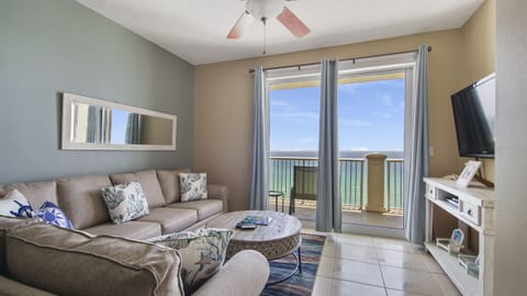 Relax in this modern living room with ocean views from the balcony.