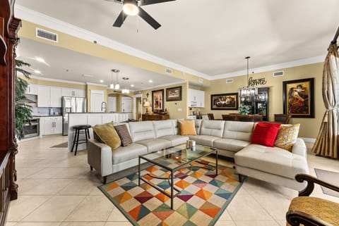 Spacious living area with a modern sectional sofa and open kitchen layout