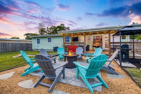 Gather around the gas fire pit as the sun goes down — your Adirondack chairs are waiting and the string lights are already on.