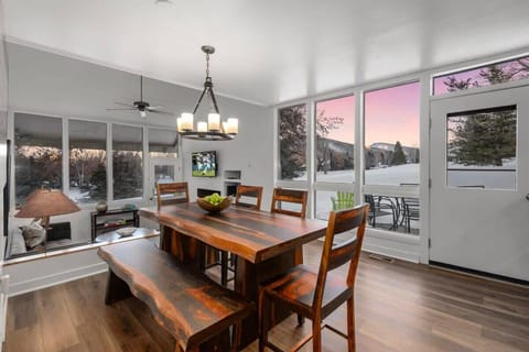 Dining Room: Gather around the stunning wood table with mountain views and natural light galore!
