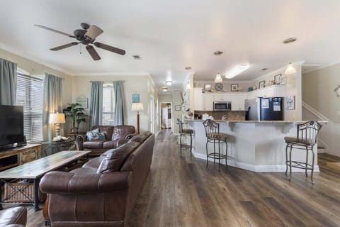 Comfortable living room with leather couches, TV, bar seating and more!!