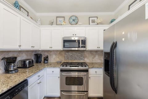 Kitchen comes with toaster, coffee maker, utensils, and cutlery.