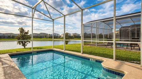 The outdoor pool area is a luxurious retreat for relaxation and entertainment. It features a large, heated swimming pool.