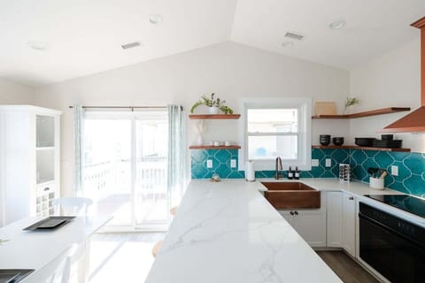 Cook with ease in the fully updated kitchen featuring modern appliances, induction stovetop, cookware, coffee maker, and everything needed for preparing meals at home