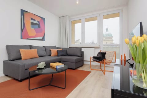 Relax in the stylish living room with a comfortable sofa and modern decor.