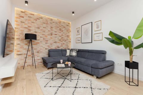 Relax in the stylish living room with a comfortable sofa and modern decor.