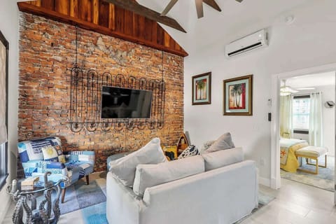 Stay here and enjoy an incomparable stay.  This beautifully renovated apartment retains much of the original details like this brick wall - erected in 1890.  Or the re-purposed wood on the cathedral ceiling - also from the same period!