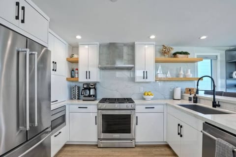 KITCHEN – This fully equipped kitchen features stainless steel appliances, sleek countertops, and all the essential cookware and tools needed for effortless meal preparation during your stay.