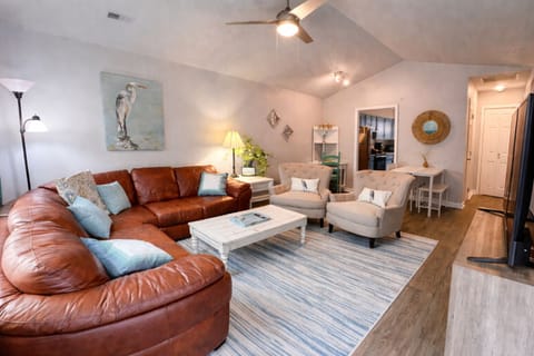 Living room with plenty of seating and a 58" smart TV. Board games, cards 