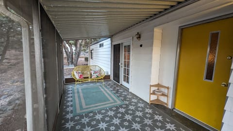 Enjoy a quiet morning on the charming retro screened porch