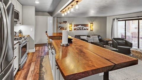 The view of the front door where the open kitchen and living room welcome you into the home.