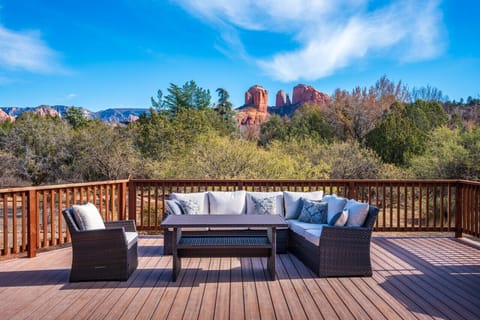 Private deck with lounge seating, BBQ grill, outdoor heater, and red rock views.