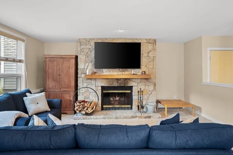 Living room with huge smart tv & fireplace!