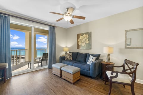 Relax in this cozy living room with ocean views and access to a balcony.