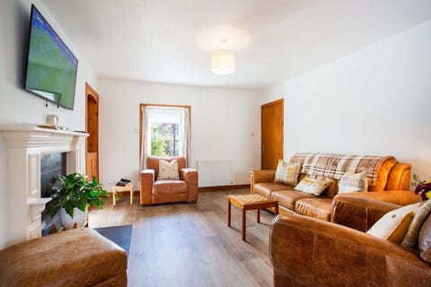 Cosy lounge with fireplace, Smart TV, and space to stretch out.