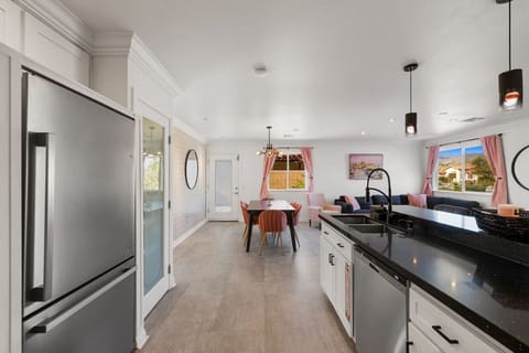 Central dining area connecting the kitchen and living room for effortless group hangouts.