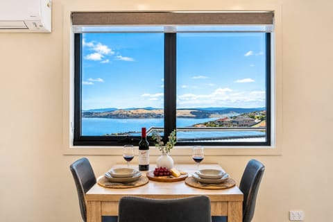 njoy breakfast or a glass of wine while taking in sweeping views across the Derwent River and surrounding hills.